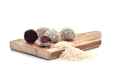 Healthy raw energy balls with cocoa, chocolate, flaxseed, on a white textured wooden background. Chocolate Truffles.