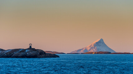 Fototapeta na wymiar Passing the Northern Polar Circle Globe on the norwegian island Vikingen with cruise ship in early morning