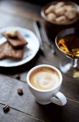 Cup of coffee on rustic wooden background. Close up.	