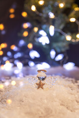 Obraz premium a small glass angel near the Christmas tree. Christmas decoration