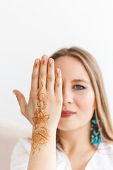 Girl of European appearance, henna drawing on hands, mahendi, girl in light clothes, yoga, spiritual development