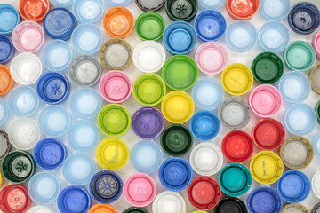 Recycled Multicolored Plastic Bottle Caps on white background