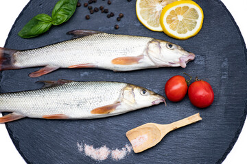 Fish with aromatic herbs, spices and vegetables - healthy food, diet or cooking concept