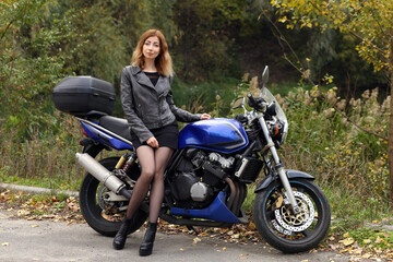 Plakat Beautiful woman sitting on the motorcycle
