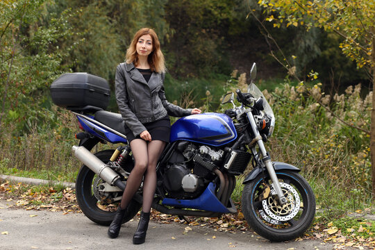 Beautiful woman sitting on the motorcycle