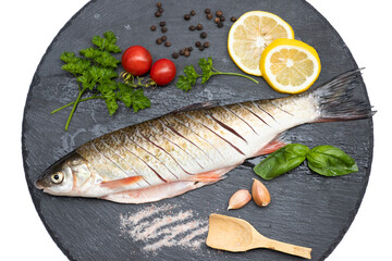 Fish with aromatic herbs, spices and vegetables - healthy food, diet or cooking concept