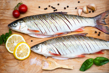 Fish with aromatic herbs, spices and vegetables - healthy food, diet or cooking concept