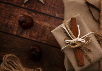 box with a gift, chestnuts and rope on a wooden table. selective focus 