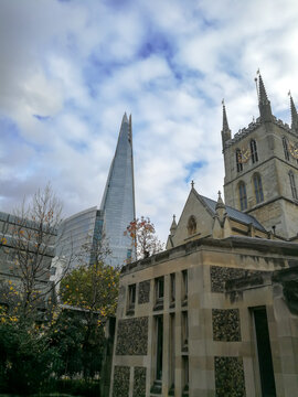 Picture of London in the winter.  View of old and new with old church with a modern skyscraper backdrop 