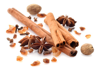 Spicy cinnamon sticks, anise stars, unrefined sugar isolated on white
