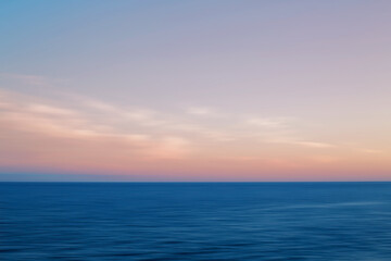 Naklejka na ściany i meble Motion blurred seascape at sunset