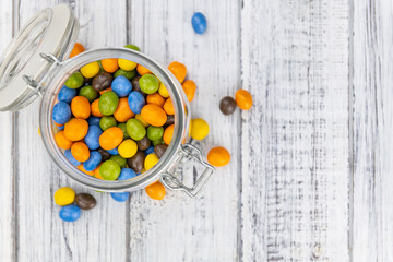 Chocolate coated peanuts (close up; selective focus)