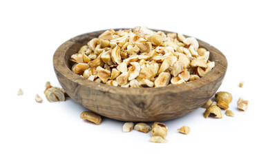 Freshly chopped Hazelnuts isolated on white background (close up; selective focus)