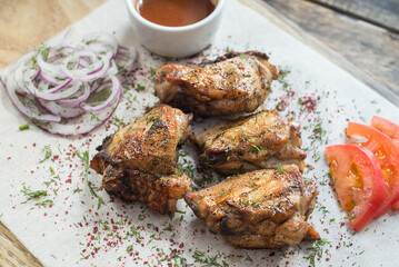 chicken thighs cooked on a grill.