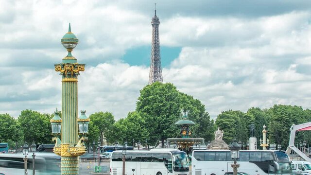 Fontaines de la Concorde on Place de la Concorde timelapse in Paris, France. Traffic on road and eiffel tower on background. Blue cloudy sky at summer day