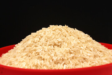 healthy raw white rice served in a red bowl 