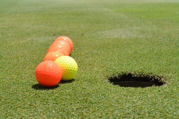 Perspective Row, Seven Orange, Yellow Glowing Golf Balls, Hole, Green Grass, Field, Unique,...