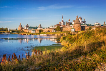 Solovetsky Monastery and yellow autumn grass on the shore