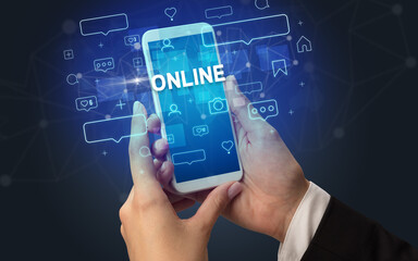 Female hand typing on smartphone with ONLINE inscription, social media concept