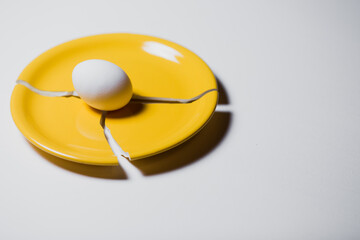 one chicken egg on a plate