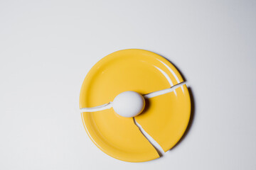 one chicken egg on a plate