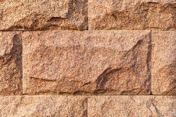 Red granite boulders are stacked on top of each other in a frame.