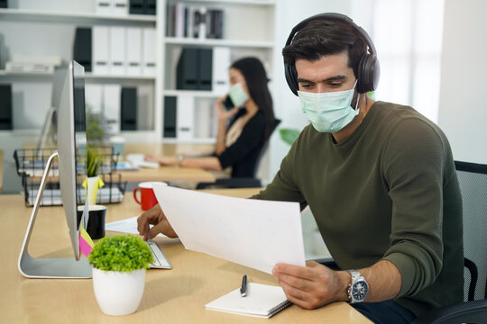 people wearing face mask and work at office
