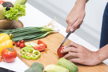 person using knife cut tomato prepare dinner