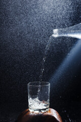 water pours from a bottle into a glass