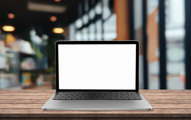Laptop blank screen on table with blur coffee shop background.