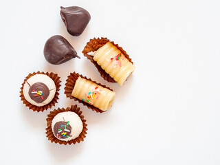 Assortment of pastries and sweets in white background for dessert or tea time. Sweet treats for fall. Flat lay with copy space