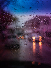 Tall abstract blurred background of city street on heavy rain
