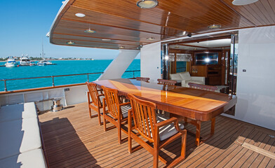 Table and chairs on rear deck of a luxury motor yacht
