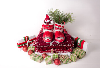 Little knitted boots with Christmas gifts and various decorations