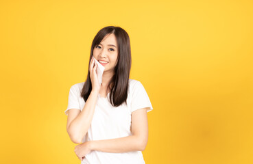 Asian young woman wearing white t-shirt standing and holding a tissue paper
