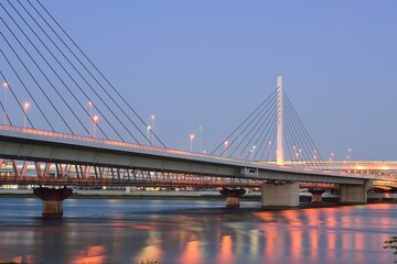 Long exposure urban landscape of suspension bridge in dusk sky background
