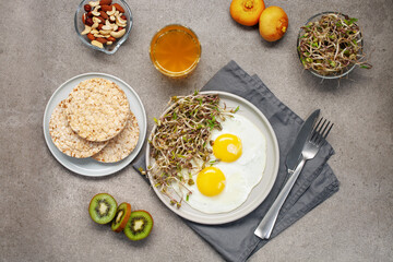 Healthy breakfast with egg, bean sprouts, fruit, honey and juice. Top view. Flat lay
