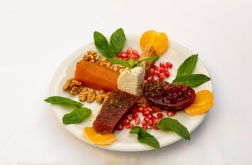 Pumpkin dessert in white plate, standing on isolated background.