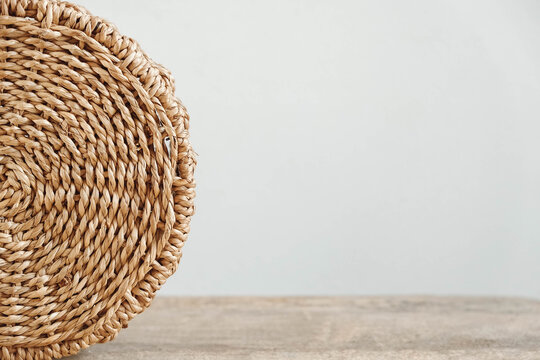 Details of a round wicker basket on an old wooden background. Copy, empty space for text