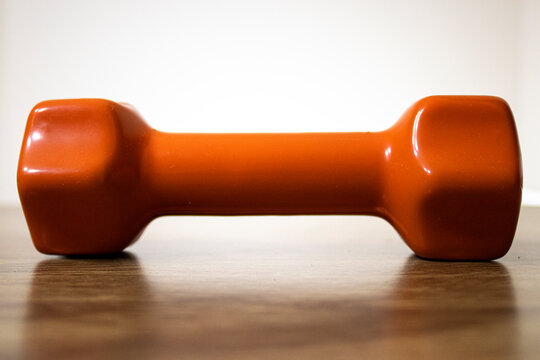 One kilogram dumbbell in orange.
