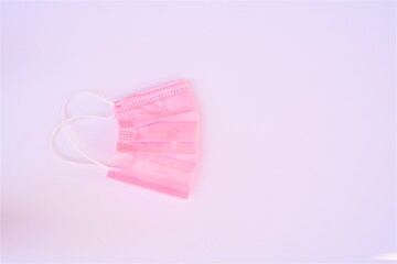 Surgical pink mask in a white background for covid pandemic