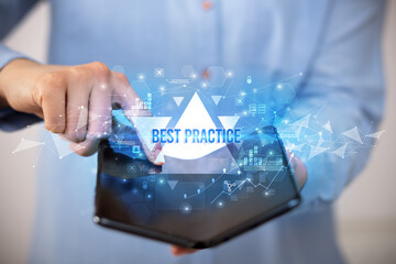 Businessman holding a foldable smartphone with BEST PRACTICE inscription, business concept