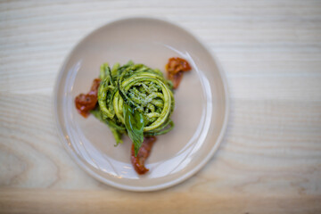 Above view of a zucchini noodles and spinach dish on a wooden table
