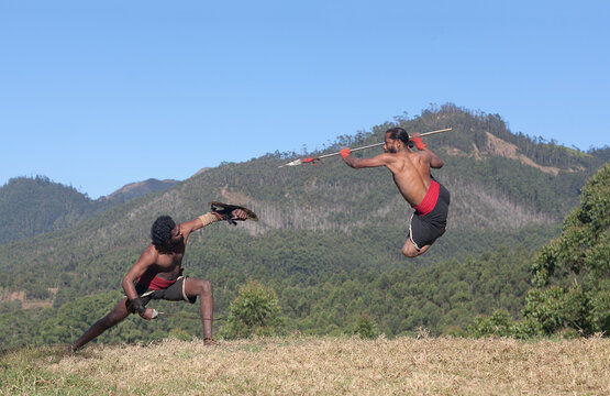 Indian fighters performing Aayudha Payattu (Weapon Combat) during Kalaripayattu Marital art demonstration in Kerala, South India