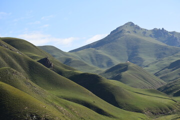 Panoramic view of green mountains, blue skies, light clouds, autumn, Qinghai, China