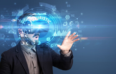Businessman looking through Virtual Reality glasses with FUTURISTIC inscription, innovative technology concept