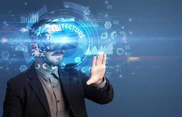Businessman looking through Virtual Reality glasses with ARCHITECTURE inscription, innovative technology concept