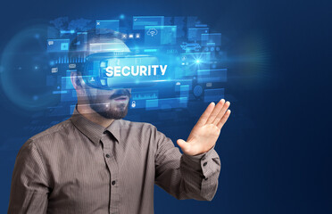 Businessman looking through Virtual Reality glasses with SECURITY inscription, innovative security concept