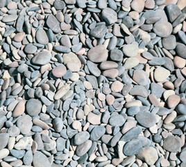 Stone pebbles on the sea as an abstract background.