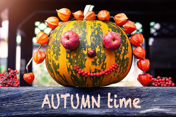  Autumn time - text on a wooden surface with a decorative pumpkin - a symbol of autumn. The concept...